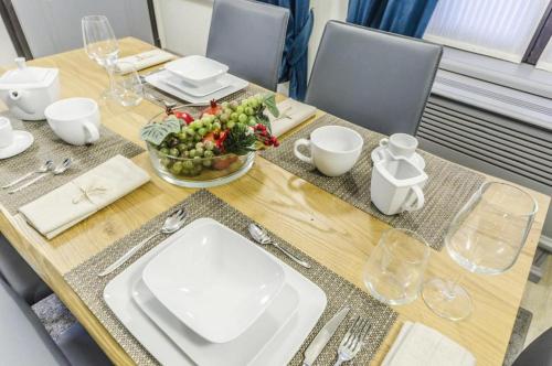 a wooden table with a bowl of fruit on it at Venice Residence in Venice