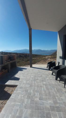 a patio with chairs and a view of the desert at Casa MoodSpot Potrerrillos vistas 360 in Cacheuta