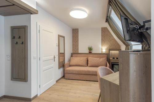 a living room with a couch and a table at Turul Villa in Sovata