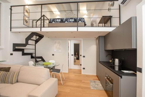 a loft apartment with a staircase and a living room at Mgm Property - Wonderful Loft Tartaglia in Milan