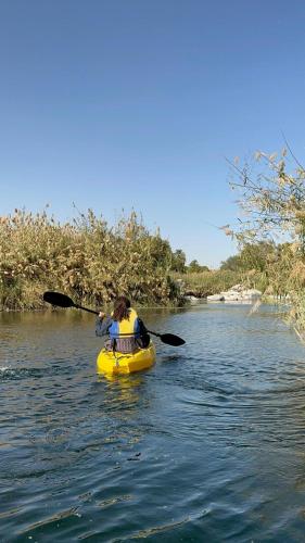 a person in a kayak on a river at Nala Narty Boutique Hotel & Farm in Aswan