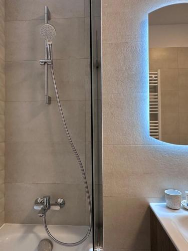 a shower in a bathroom with a glass door at ELA Cotroceni Residence - self check in & free parking in Bucharest
