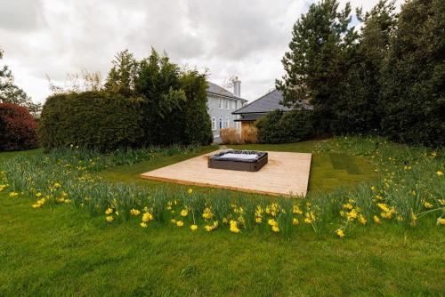a bed in the middle of a field of flowers at Rochtaine Kilkenny, Mount Juliet Estate in Ballynamona