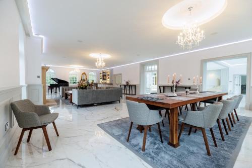 a dining room and living room with a table and chairs at Rochtaine Kilkenny, Mount Juliet Estate in Ballynamona