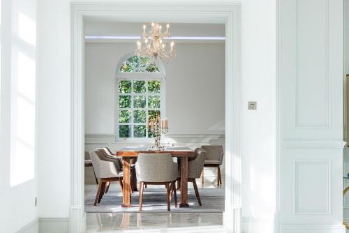 a dining room with a table and chairs and a window at Rochtaine Kilkenny, Mount Juliet Estate in Ballynamona