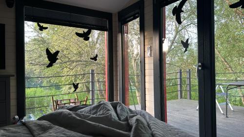 a bedroom with bats on the windows of a house at Gabčíkovo - Prístav in Gabčíkovo