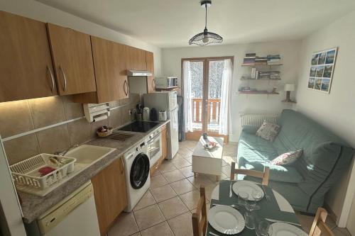 a kitchen with a couch and a living room at Le lac de l'Oule - L'Eterle de la Clarée in Névache