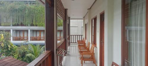 a balcony with chairs and a pool in a building at Komodo Lodge in Labuan Bajo