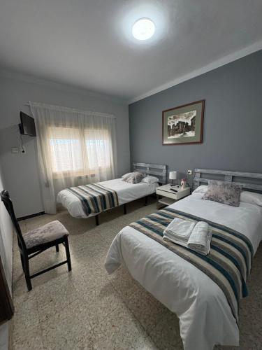 Ένα ή περισσότερα κρεβάτια σε δωμάτιο στο Hostal Pueblo Viejo