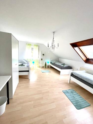 a living room with two beds and a room with a window at Gemütliche Wohnung für 5 Personen, Playmobil, Palm Beach in Stein bei Nürnberg