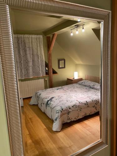 a bedroom with a bed and a large mirror at Chalupa u Žalských in Benecko