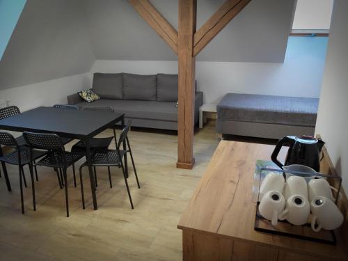 a living room with a table and chairs and a couch at Sosnówka Pokoje Gościnne in Borne Sulinowo