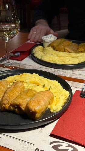 two plates of food on a table with eggs at Motel M Vlasenica in Vlasenica