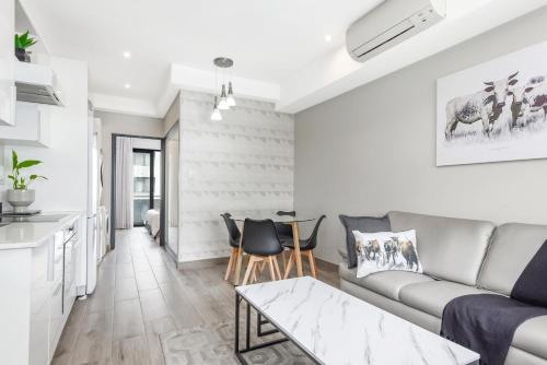 a living room with a couch and a table at The Regency Apartments in Pretoria