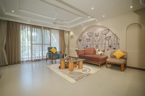 a living room with a couch and a table at VILLA M- SAVANNAH 7- 5BHK Brand New Villa in Calangute with Private Pool, Near Beach, free Breakfast, north goa in Goa