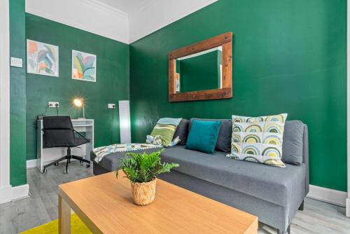 a living room with a couch and a mirror at Central Kirkintilloch 2 Bed App in Kirkintilloch