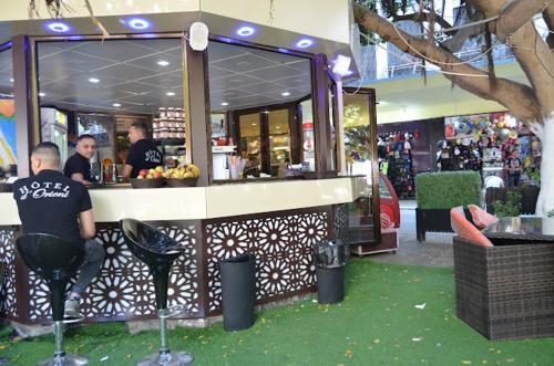 a man standing in front of a counter in a store at Hotel D'orient in Annaba