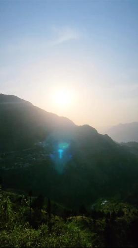 a view of the sun setting on a mountain at Sheetal Restaurant in Mussoorie