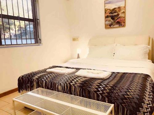 a bedroom with a bed with two towels on it at Channel View in Blacksmiths