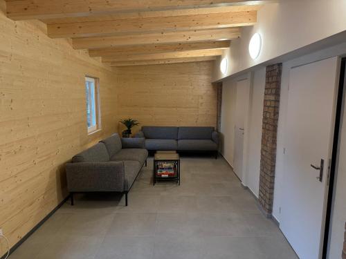 a living room with two couches and a table at Apartmán Rozárka in Deštné v Orlických horách