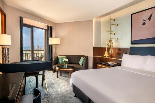 a hotel room with a bed and a desk at Sofitel Cairo Downtown Nile in Cairo