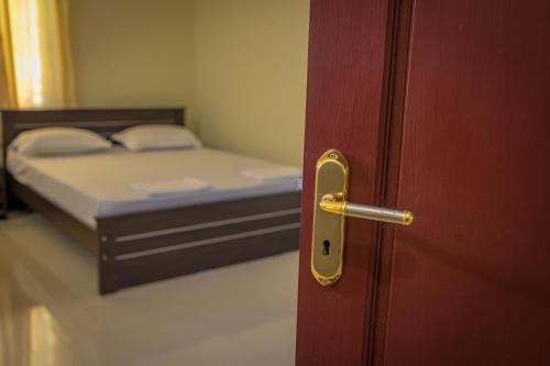 a door to a room with a bed in a room at Ganesh Home Stays in Tirunelveli
