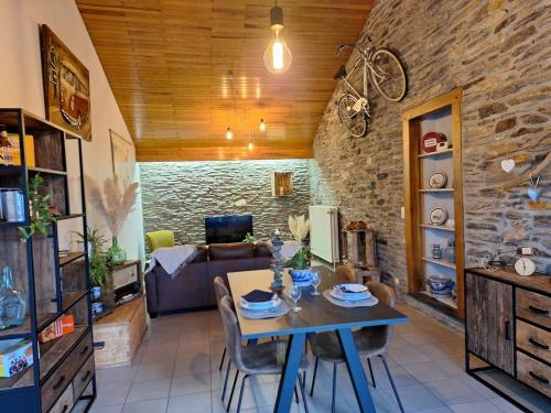 a living room with a table and a couch at Gite Le Grenier in Lierneux