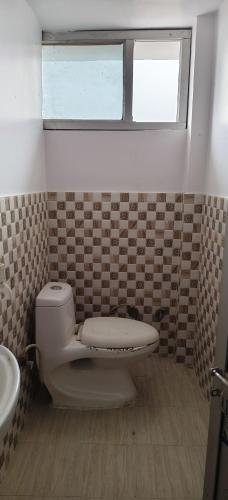 a bathroom with a toilet and a sink at Geeta Teerth Guest House AC and Non AC Rooms in Ayodhya
