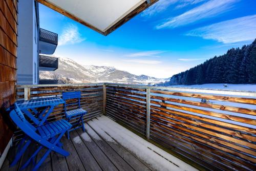 a deck with two chairs and a view of the mountains at Appartement Klosterhügel in Haus im Ennstal