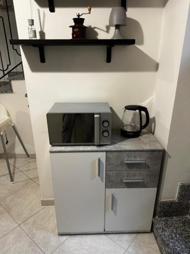 a microwave sitting on top of a counter at Residenza Dartuffo - Apartment - City Centre in Scilla