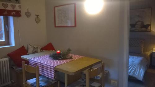 a dining room with a table with a candle on it at Chalet Do Costa in Pozza di Fassa
