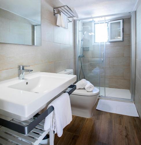 a bathroom with a sink and a toilet and a shower at Apartamentos Can Guasch Formentera in La Savina