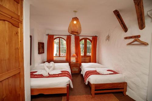 Katil atau katil-katil dalam bilik di Hostal Madre Tierra