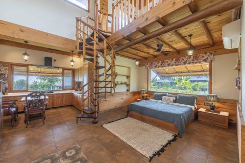 a bedroom with a bed and a spiral staircase at Echor Hill Farm Cottages Palampur in Pālampur