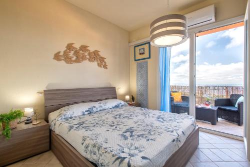 a bedroom with a bed and a view of a balcony at Rifugio Costiero in Cascabraga