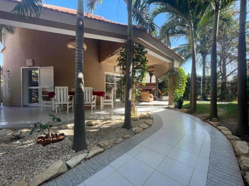 a house with palm trees and a walkway at Agence Adjana Resort - Résidence du Port 3 in Sali Tapé