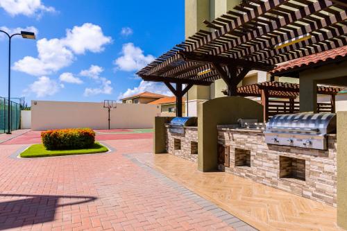 a patio with awning and flowers in a building at Palm Aruba 408 in Palm-Eagle Beach