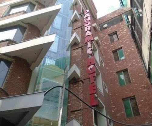 a building with a sign on the side of it at Panoramic Hotel Lahore in Lahore