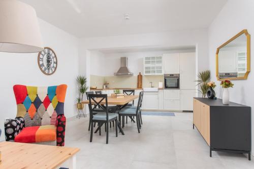 a kitchen and dining room with a table and chairs at Villa Magnolia with heated Pool and Jacuzzi, near sea in Tugare