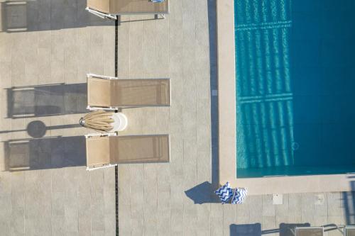 an overhead view of a pool with chairs and lights at Villa Magnolia with heated Pool and Jacuzzi, near sea in Tugare