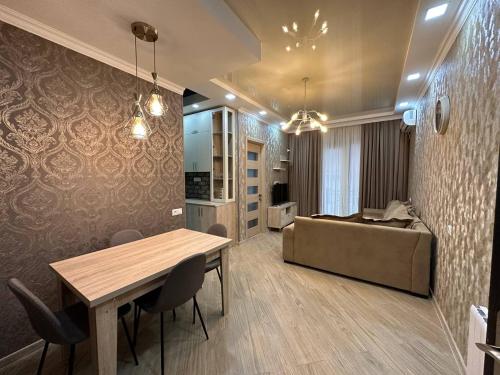 a living room with a table and a couch at Marika apartment in Kutaisi