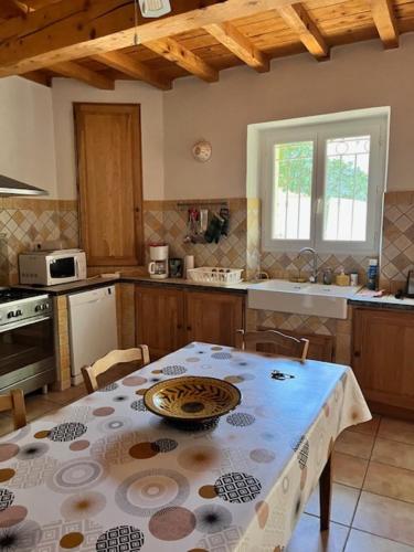 une cuisine avec une table avec une assiette dessus dans l'établissement Maison de village en Provence, à Mouriès