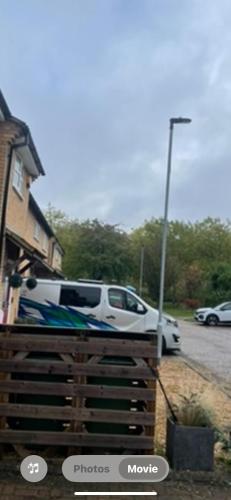 a white truck parked in front of a house at J&J stays 5 bedroom detached house in Peterborough with parking in Peterborough