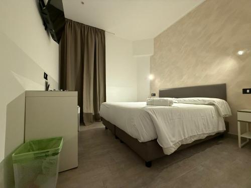 a bedroom with a large bed and a dresser in it at Relais Merulana Guest House in Rome