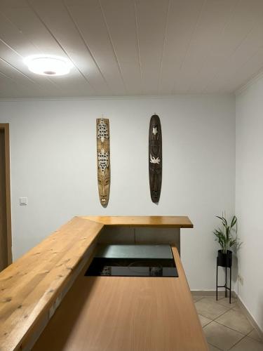 a table in a room with two vases on the wall at Souterrain Whirlpool-Apartment nahe Phantasialand in Weilerswist
