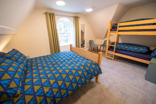 Ένα ή περισσότερα κρεβάτια σε δωμάτιο στο Braemar Youth Hostel