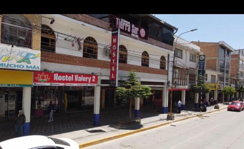 a city street with buildings and people walking on the street at Hotel valery 2 in Huaraz