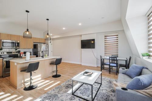 a living room and kitchen with a couch and a table at Modern & Cozy Downtown Apartment in Cincinnati in Cincinnati