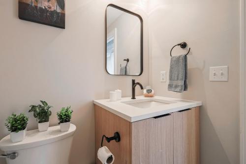 a bathroom with a sink and a toilet at Modern & Cozy Downtown Apartment in Cincinnati in Cincinnati