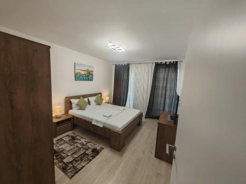 a bedroom with a bed and a window at Urban Luxury Flats - Cozy Apartments at Coresi Mall #Brasov in Braşov
